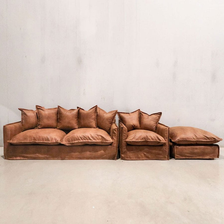 The Cloud Ottoman with Tan Leatherette Slipcover By Black Mango Interiors