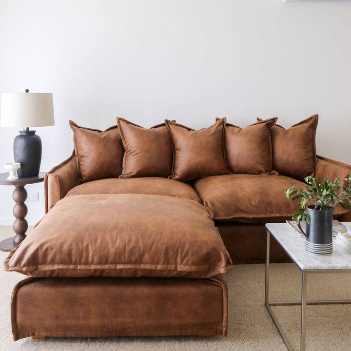 The Cloud Ottoman with Tan Leatherette Slipcover By Black Mango Interiors