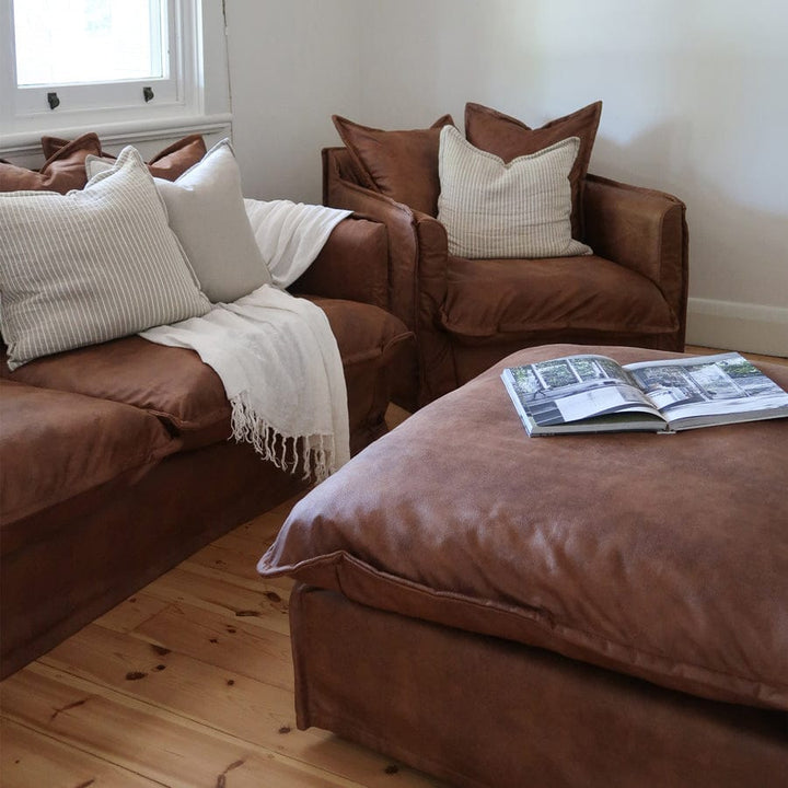 The Cloud Ottoman with Tan Leatherette Slipcover By Black Mango Interiors